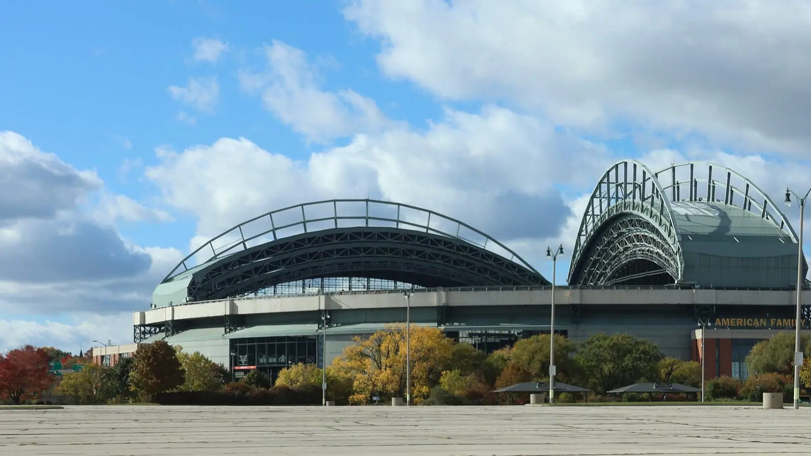 Exterior of American Family Field in Milwaukee with its fan-shaped retractable roof under a blue sky